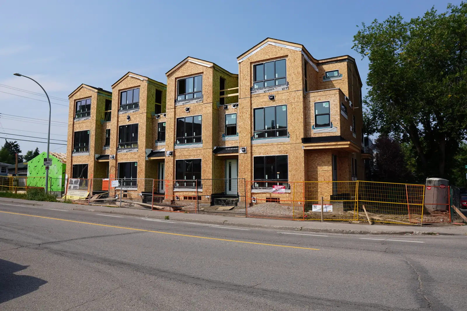 infill townhouse frames, yellow sheathing, street