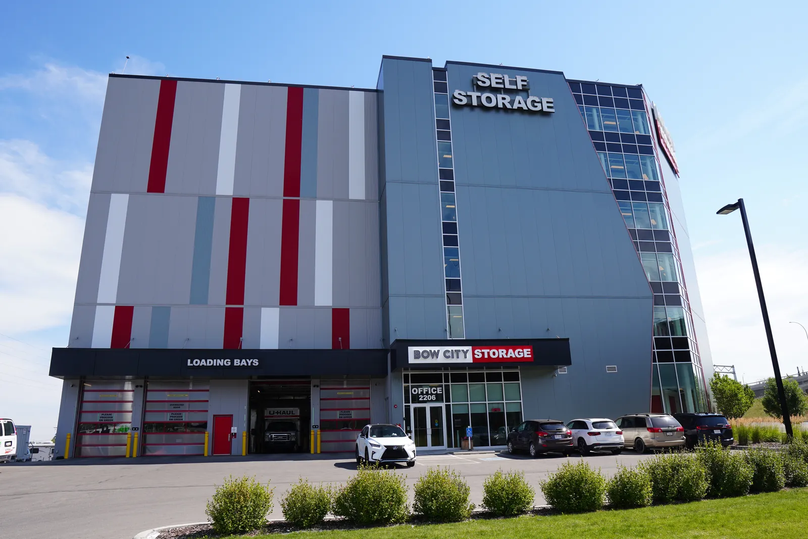 self-storage straight-on, calm sky left, hedge